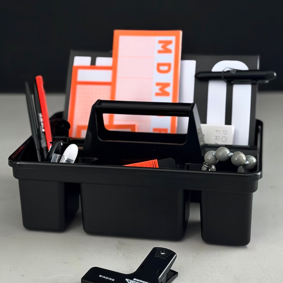 Schwarze Toolbox mit Schreibtischutensilien