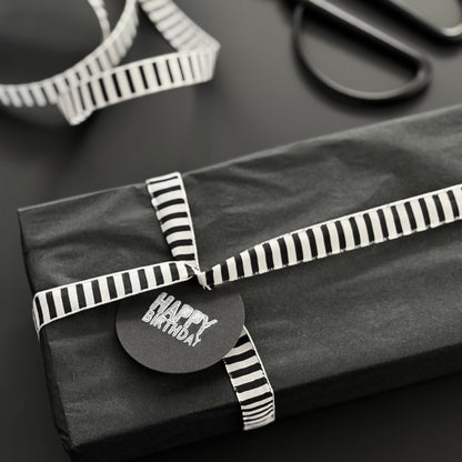 Schwarz Weiß gestreiftes Schleifenband um Geschenke zu verpacken.
